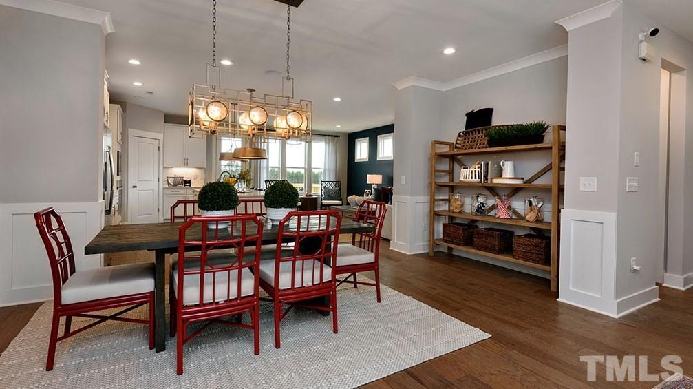 6940 Leesville Road, Unit 10 Raleigh, NC 27613 - Photo 9 of 38 a dining room with furniture a rug and wooden floor