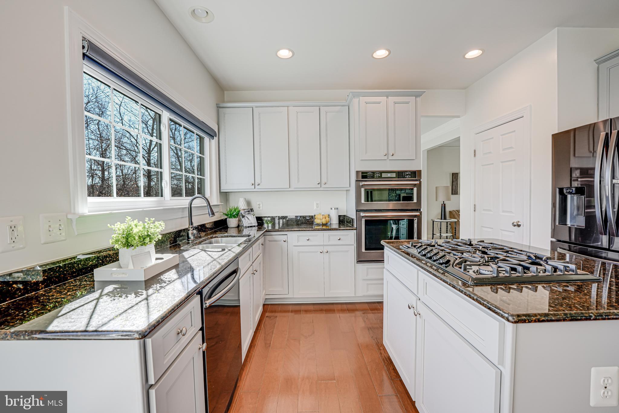 17583 Summer Duck Drive Dumfries, VA 22026 - Photo 12 of 49 a kitchen with a sink stove and refrigerator