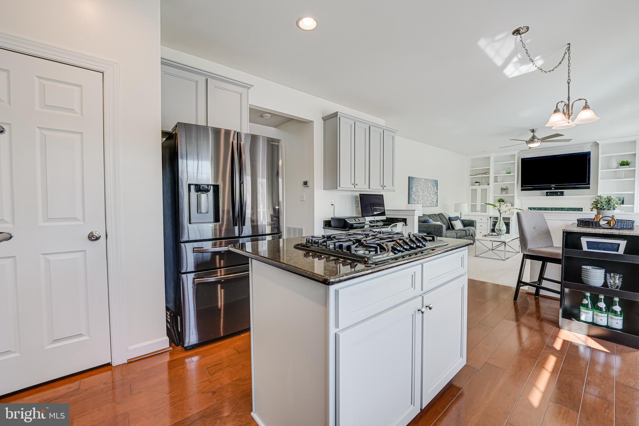 17583 Summer Duck Drive Dumfries, VA 22026 - Photo 13 of 49 a kitchen with stainless steel appliances a stove a refrigerator and a dining table
