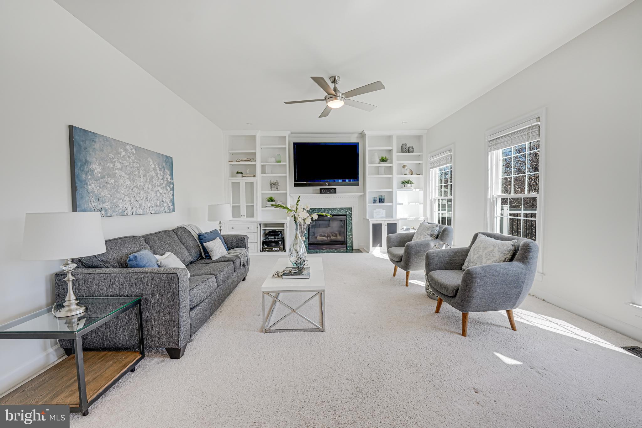 17583 Summer Duck Drive Dumfries, VA 22026 - Photo 20 of 49 a living room with furniture a flat screen tv and a fireplace