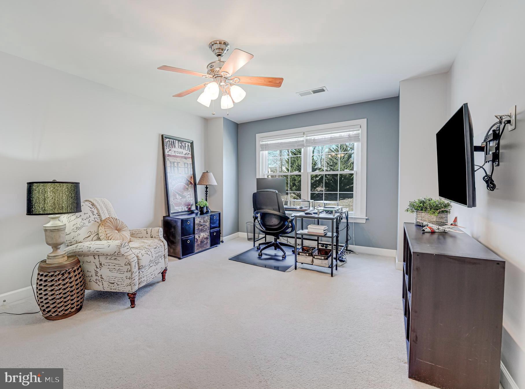 17583 Summer Duck Drive Dumfries, VA 22026 - Photo 24 of 49 a bedroom with furniture and a flat screen tv