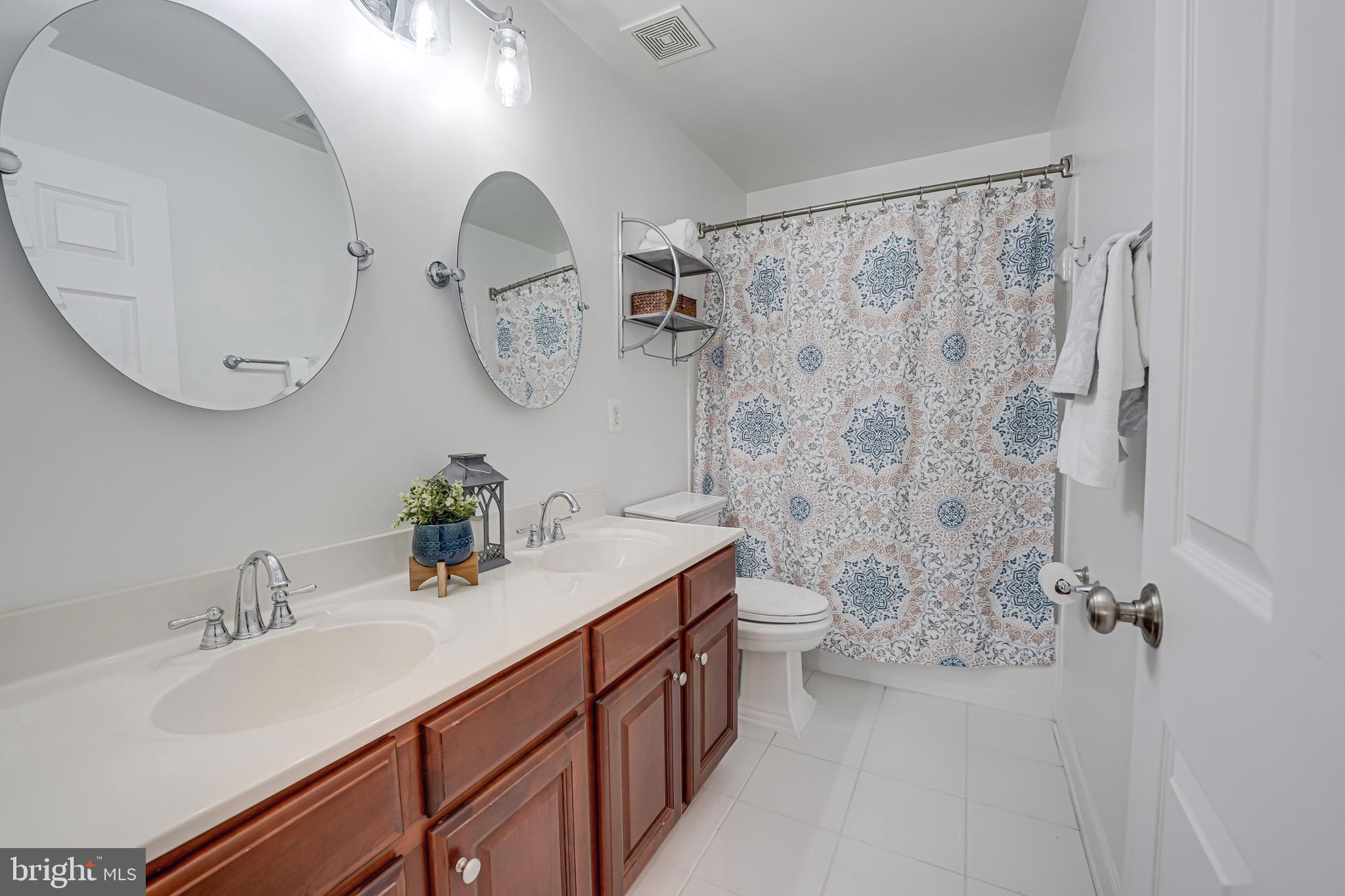 17583 Summer Duck Drive Dumfries, VA 22026 - Photo 25 of 49 a bathroom with a double vanity sink and mirror