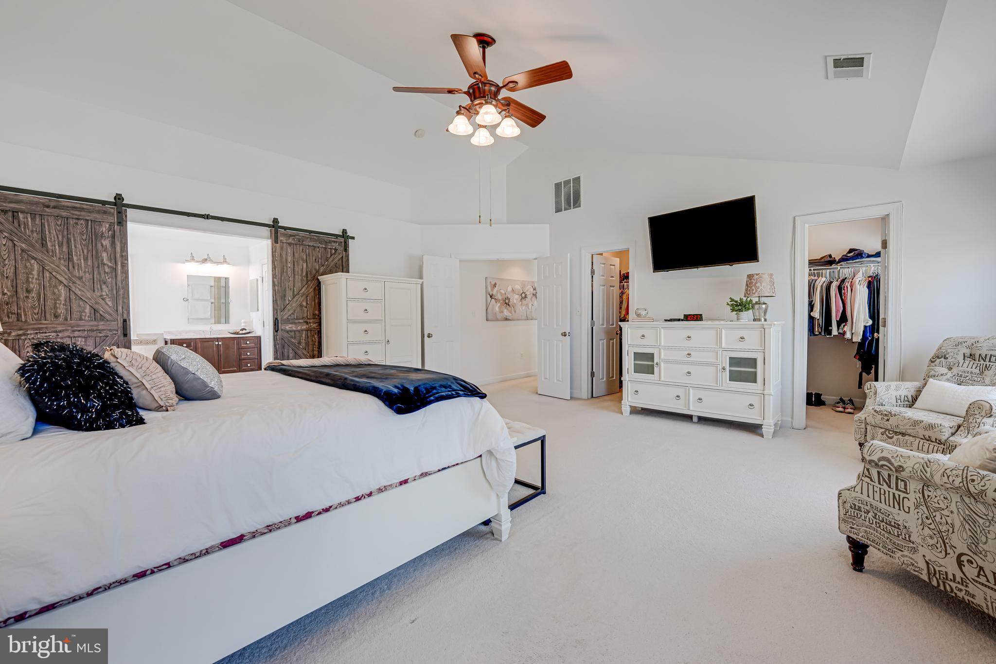 17583 Summer Duck Drive Dumfries, VA 22026 - Photo 30 of 49 a spacious bedroom with a bed and a tv