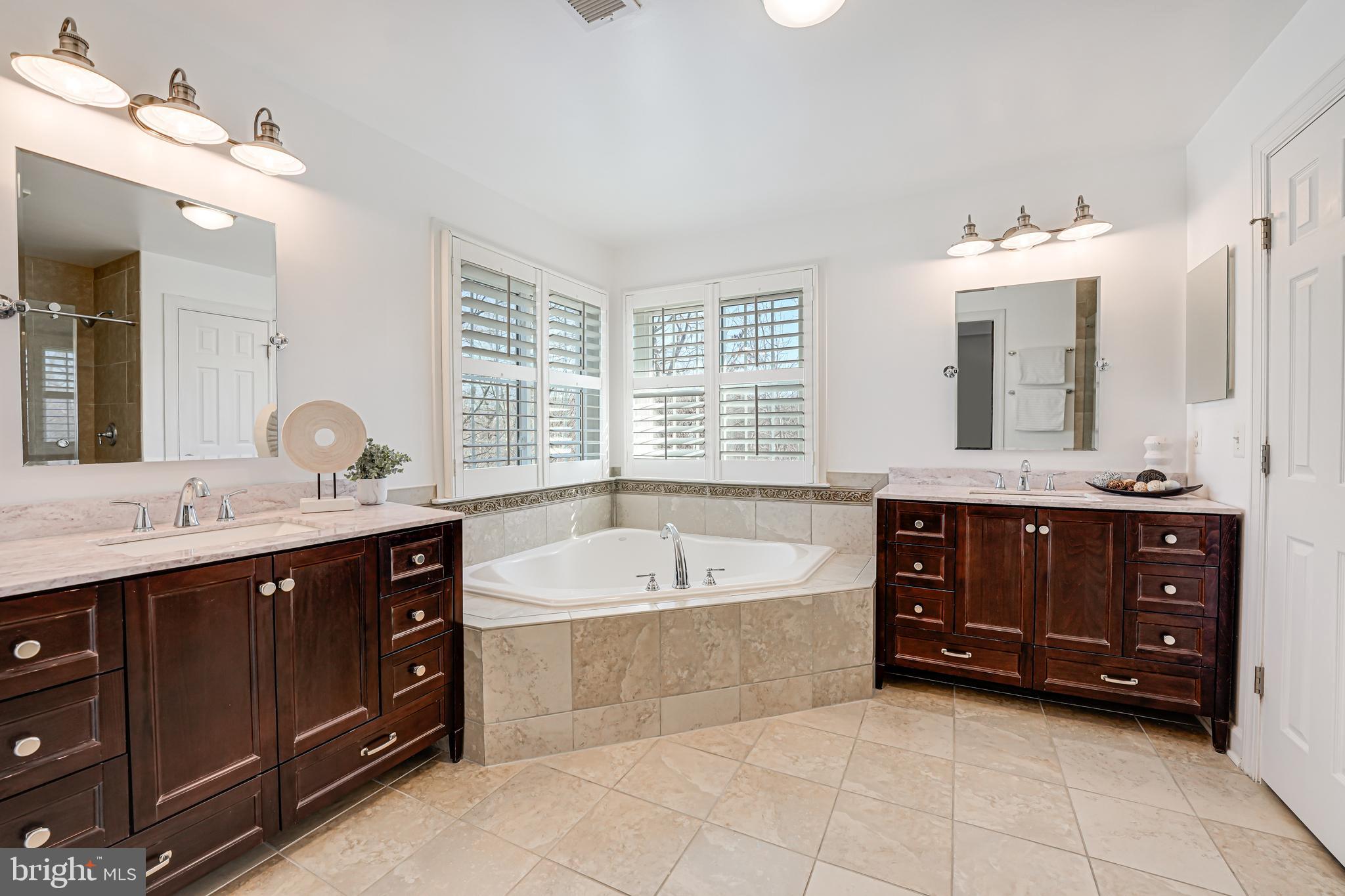 17583 Summer Duck Drive Dumfries, VA 22026 - Photo 31 of 49 a spacious bathroom with a tub double sink and mirror