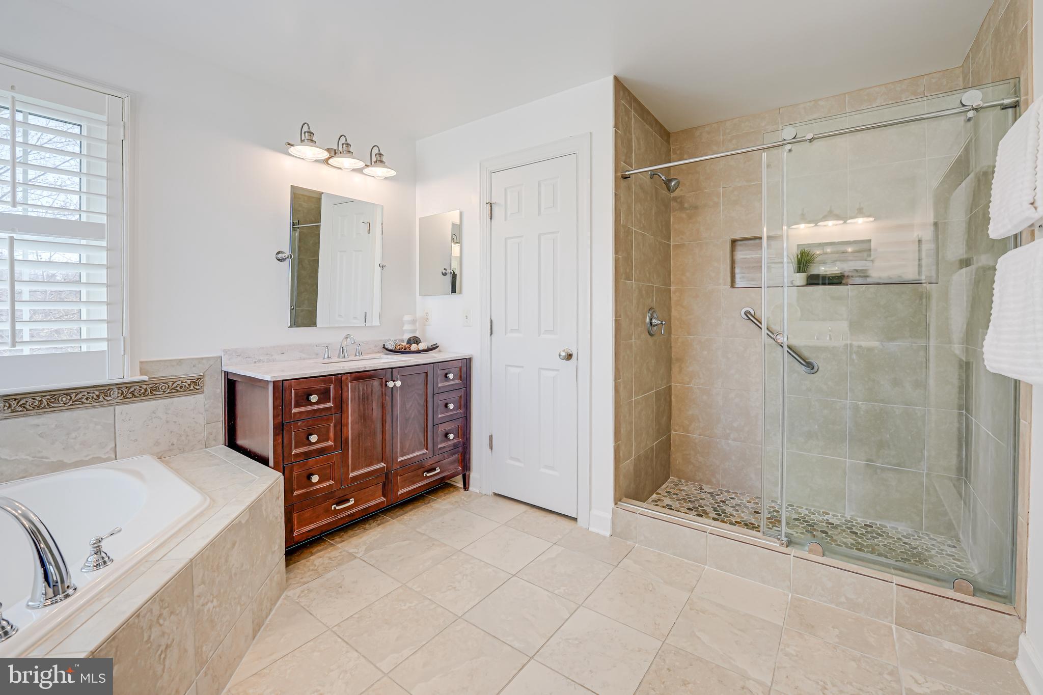 17583 Summer Duck Drive Dumfries, VA 22026 - Photo 32 of 49 a bathroom with a tub shower vanity and sink