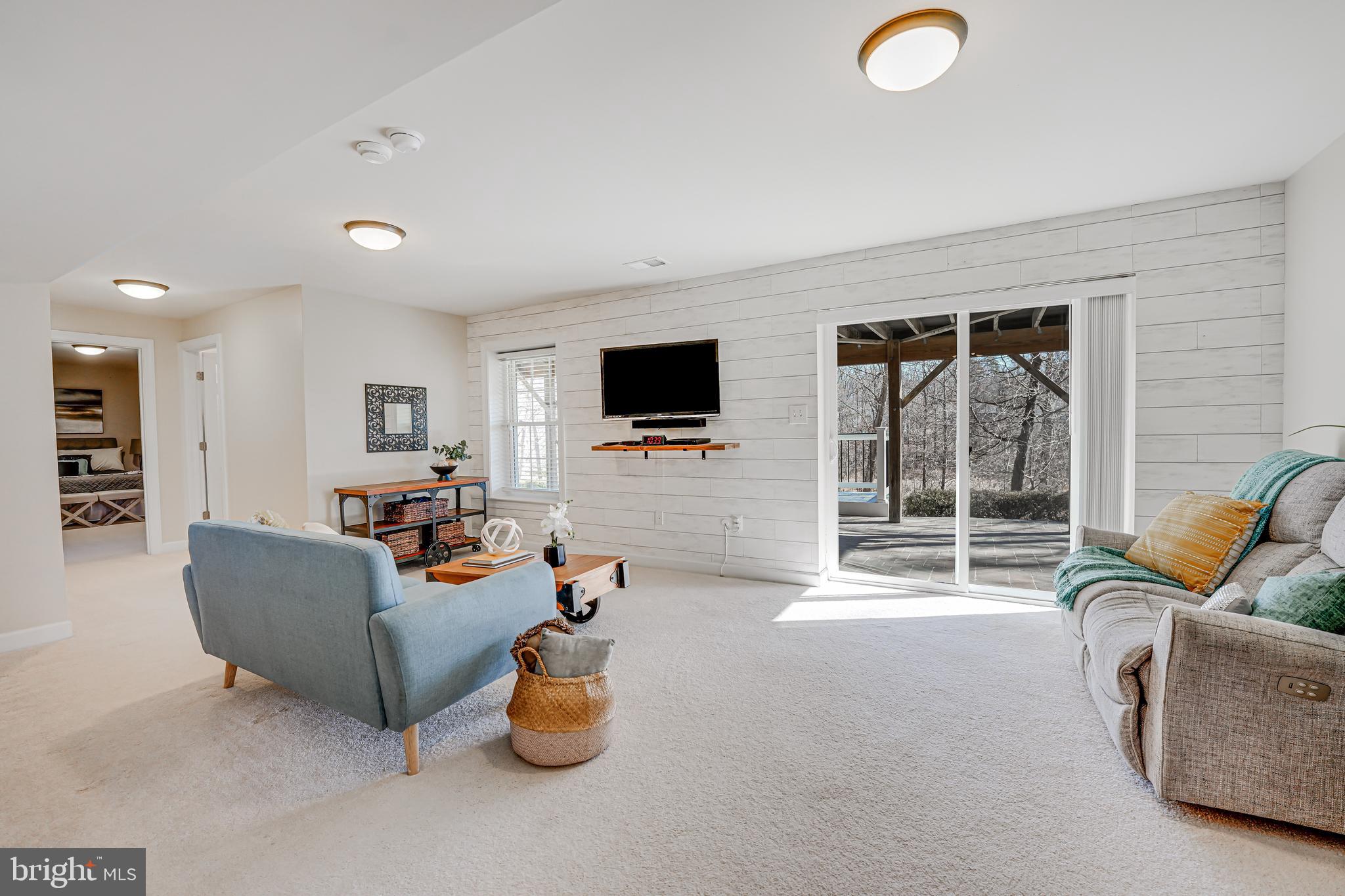 17583 Summer Duck Drive Dumfries, VA 22026 - Photo 34 of 49 a living room with furniture and a flat screen tv