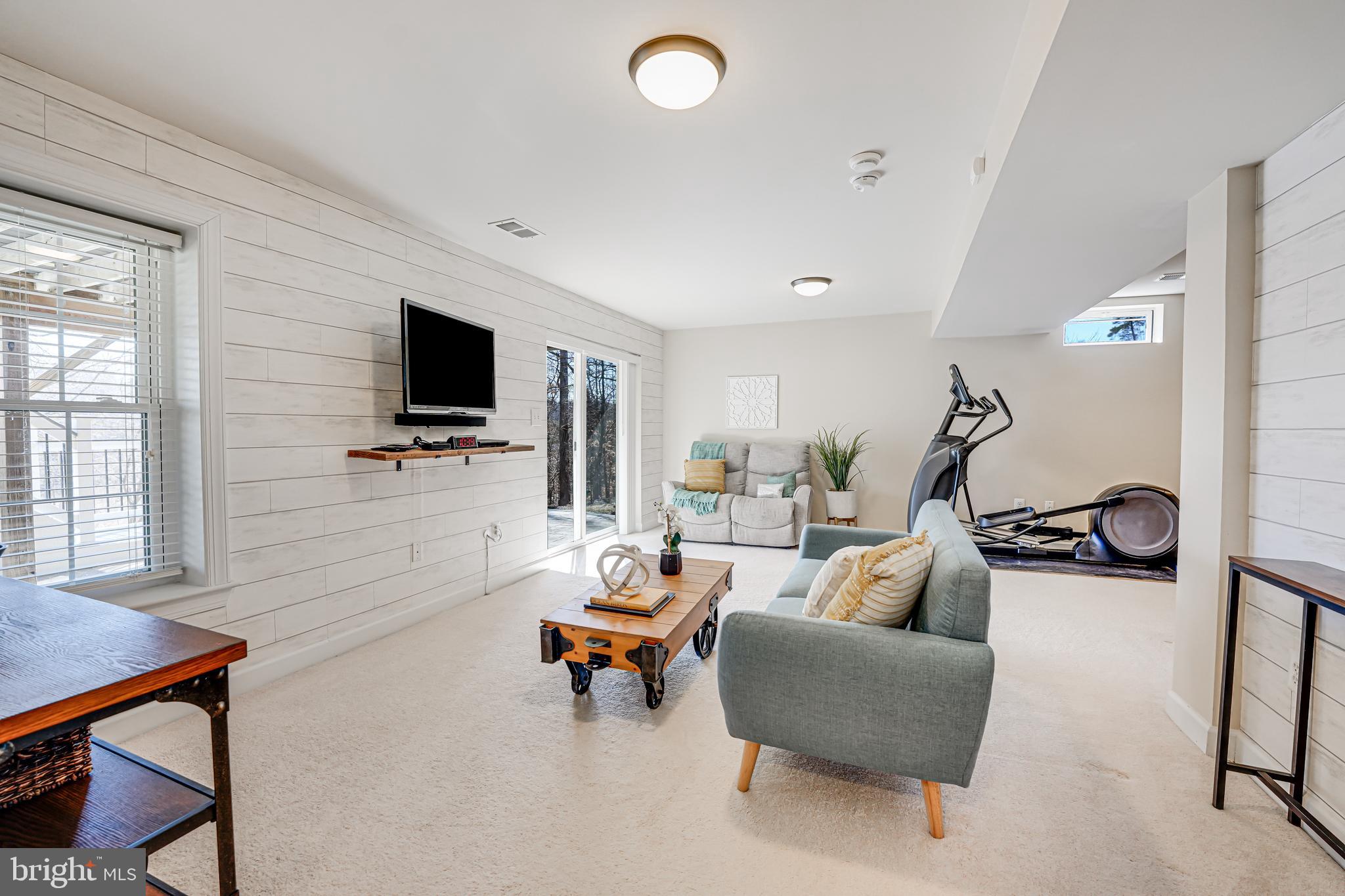17583 Summer Duck Drive Dumfries, VA 22026 - Photo 36 of 49 a living room with furniture and a flat screen tv