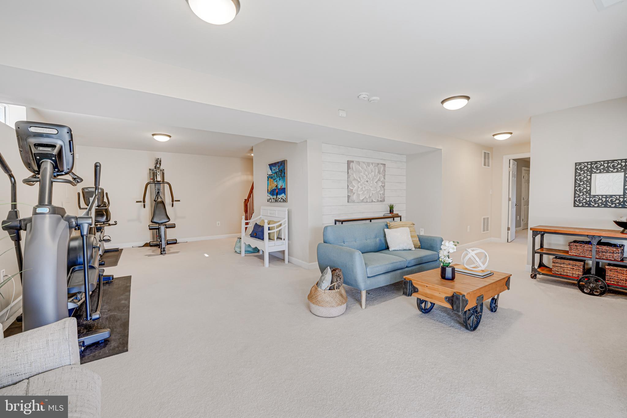 17583 Summer Duck Drive Dumfries, VA 22026 - Photo 37 of 49 a living room with furniture and a gym machine