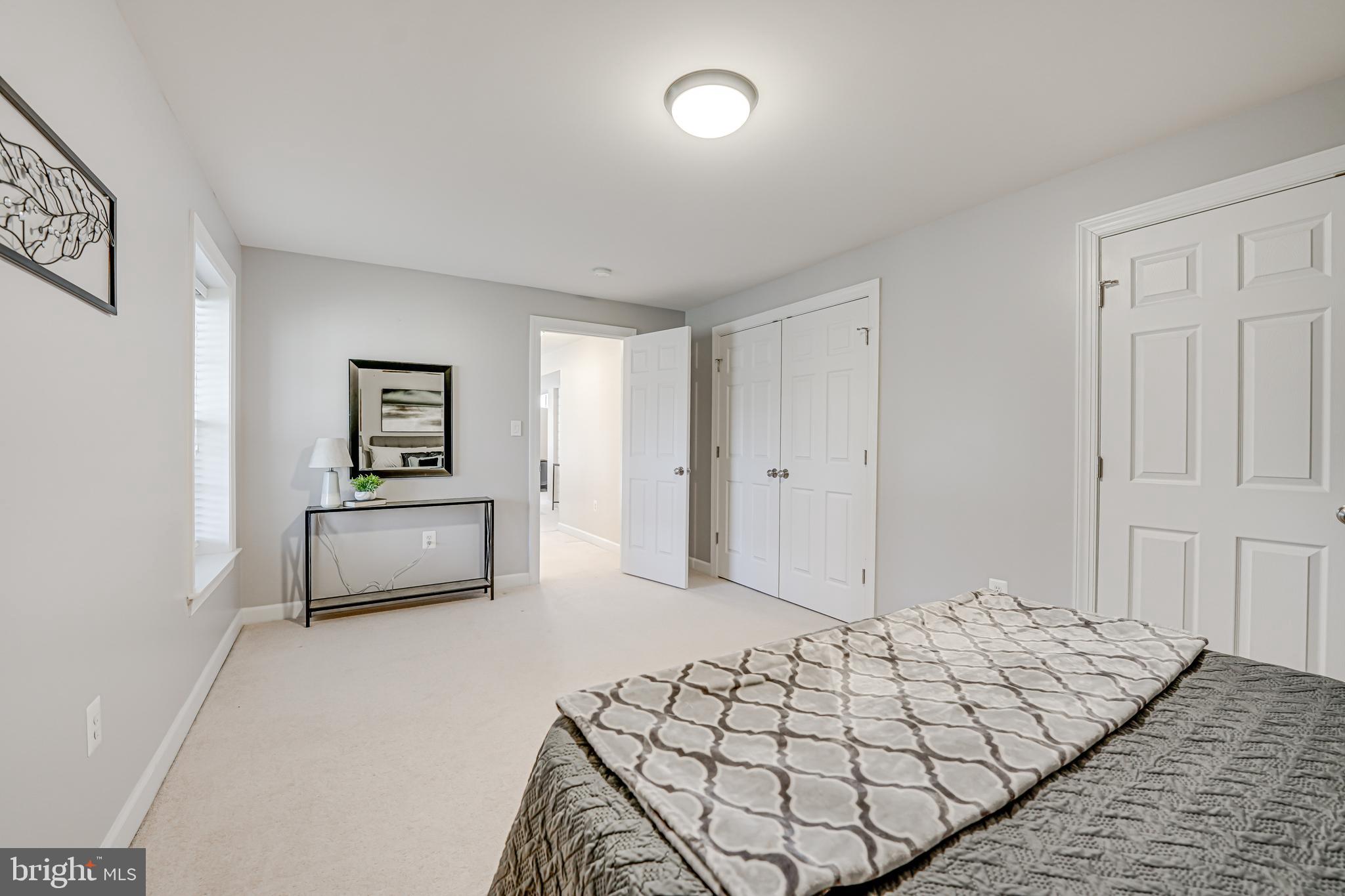 17583 Summer Duck Drive Dumfries, VA 22026 - Photo 39 of 49 a bedroom with bed and a night stand