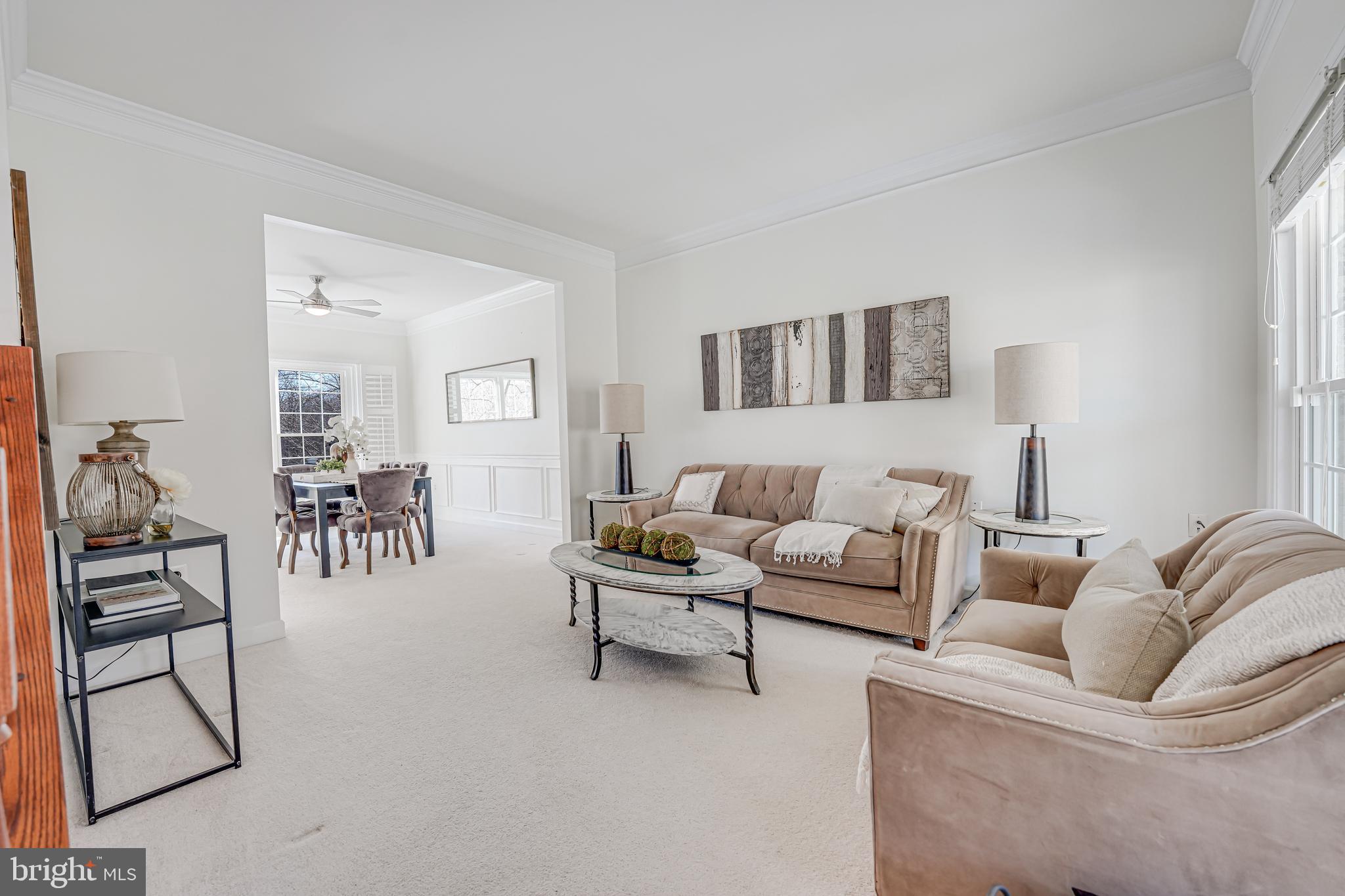 17583 Summer Duck Drive Dumfries, VA 22026 - Photo 9 of 49 a living room with furniture and a dining area with kitchen view