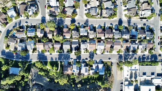 a view of a brick house with a yard