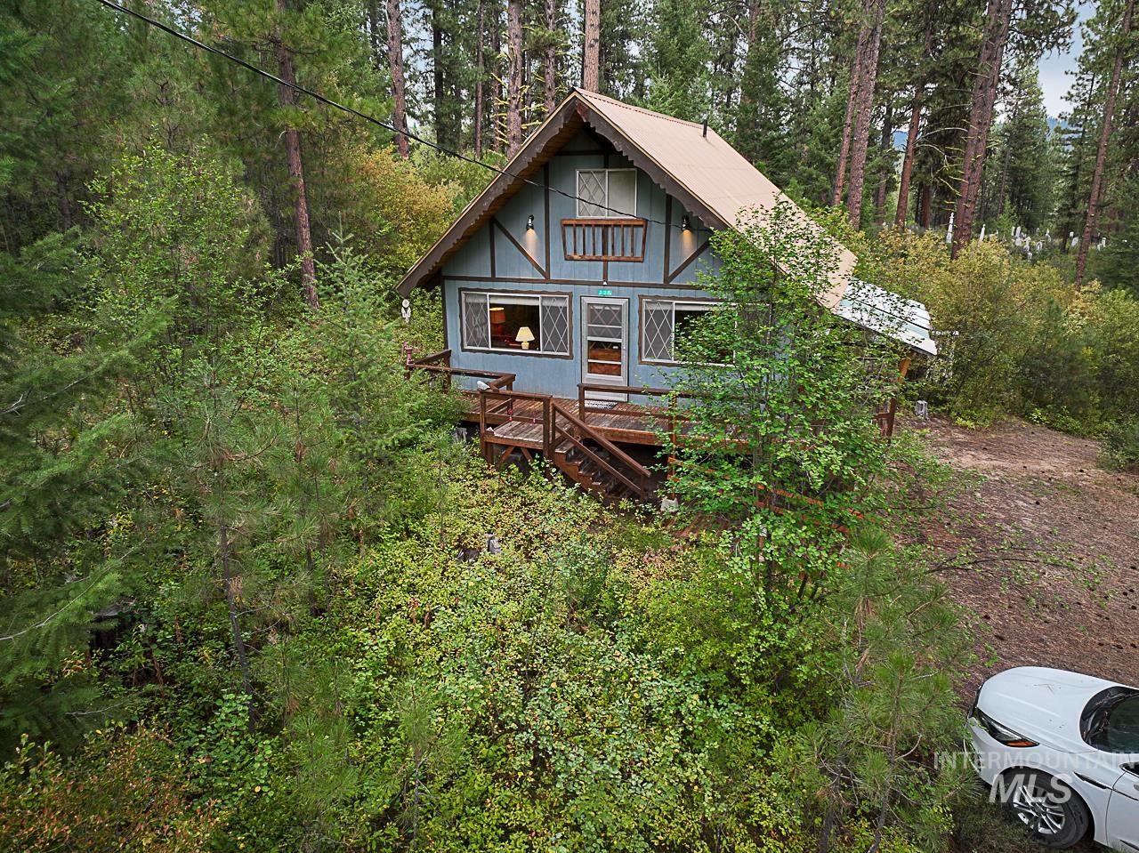 225 Mesplie Road Placerville, ID 83666 - Photo 1 of 39 Rear view of house with a view of trees and a wooden deck