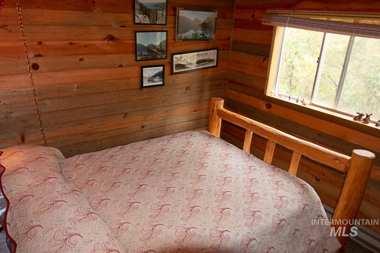 225 Mesplie Road Placerville, ID 83666 - Photo 12 of 39 Bedroom with wood walls