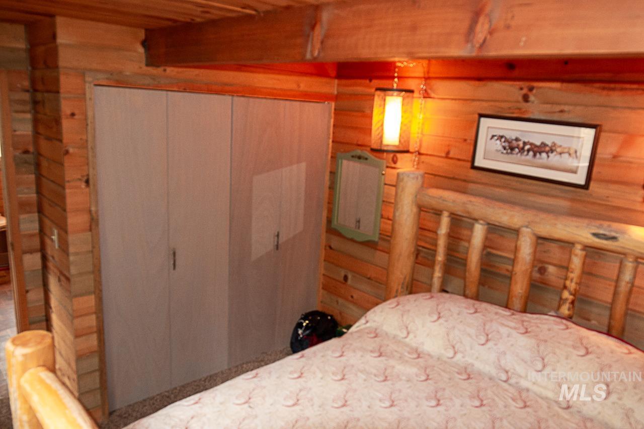 225 Mesplie Road Placerville, ID 83666 - Photo 21 of 39 Bedroom with wooden walls