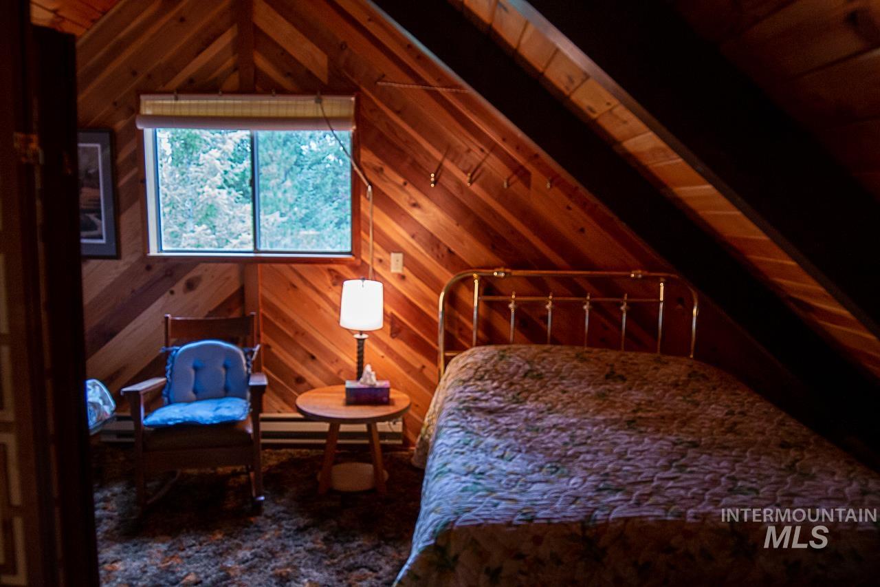 225 Mesplie Road Placerville, ID 83666 - Photo 26 of 39 Bedroom with wood walls and wood ceiling