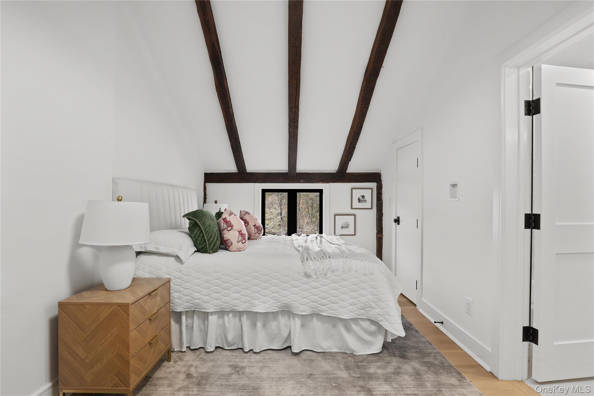 39 Old Snake Hill Road Pound Ridge, NY 10576 - Photo 20 of 37 a bedroom with a bed and a mirror