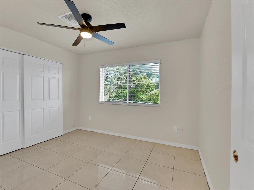 308 Northwest 17th Terrace Pompano Beach, FL 33069 - Photo 11 of 43 an empty room with a ceiling fan and window