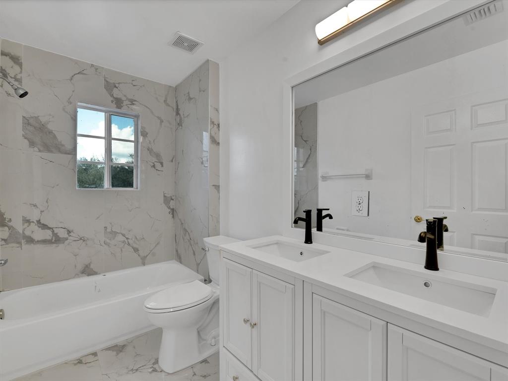 308 Northwest 17th Terrace Pompano Beach, FL 33069 - Photo 13 of 43 a bathroom with a sink a toilet and shower
