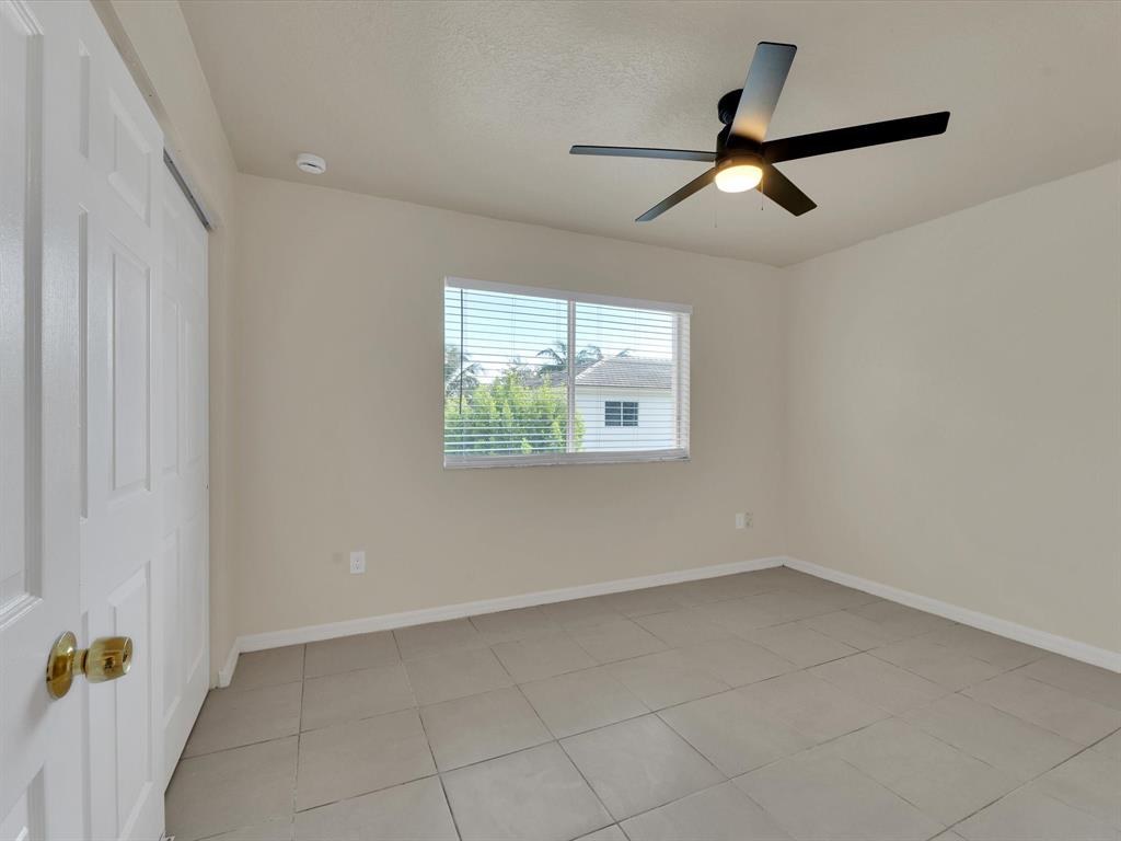 308 Northwest 17th Terrace Pompano Beach, FL 33069 - Photo 14 of 43 an empty room with a window and a ceiling fan