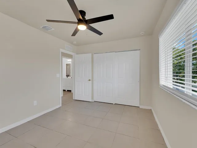 a view of a livingroom with a ceiling fan and window