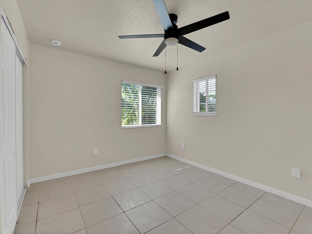 308 Northwest 17th Terrace Pompano Beach, FL 33069 - Photo 16 of 43 wooden floor in an empty room with a window