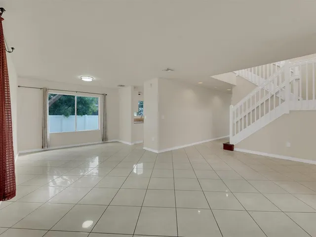 a view of an empty room with windows