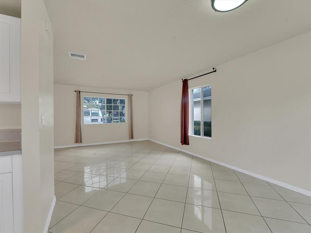 308 Northwest 17th Terrace Pompano Beach, FL 33069 - Photo 25 of 43 an empty room with windows