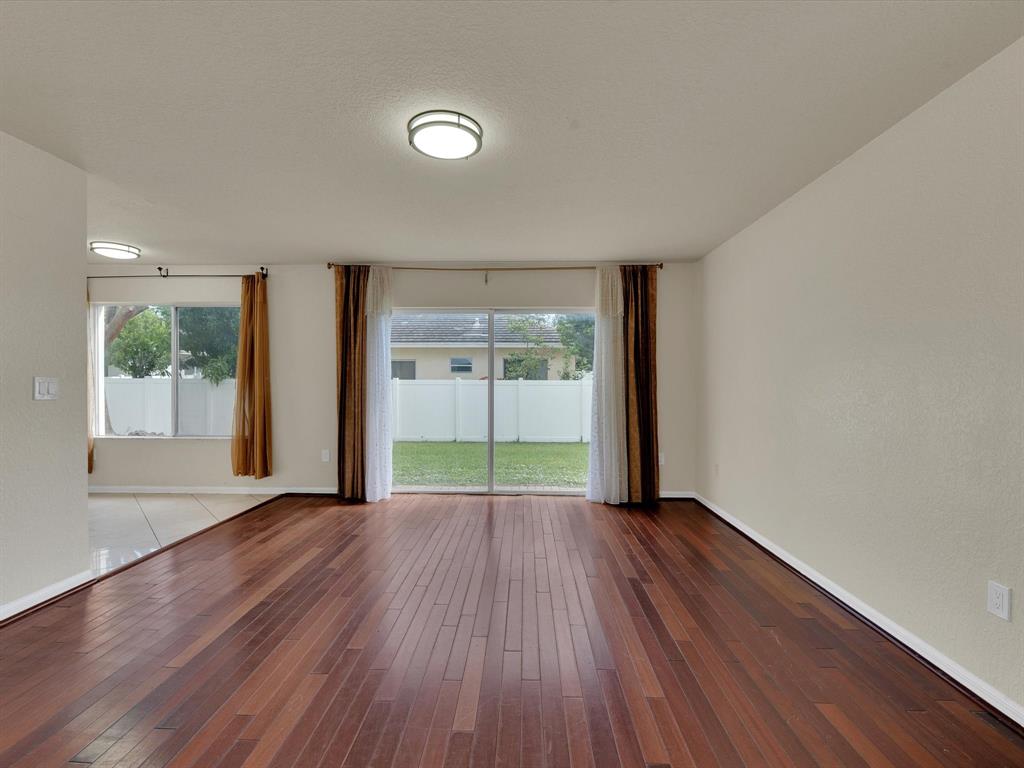 308 Northwest 17th Terrace Pompano Beach, FL 33069 - Photo 34 of 43 a view of an empty room with wooden floor and a window