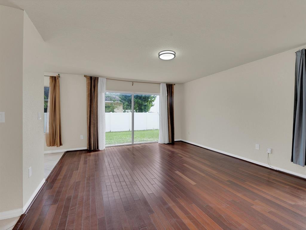 308 Northwest 17th Terrace Pompano Beach, FL 33069 - Photo 35 of 43 wooden floor in an empty room with a window