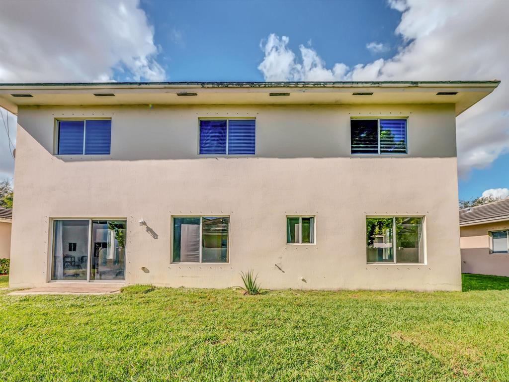 308 Northwest 17th Terrace Pompano Beach, FL 33069 - Photo 39 of 43 a front view of a house with a yard