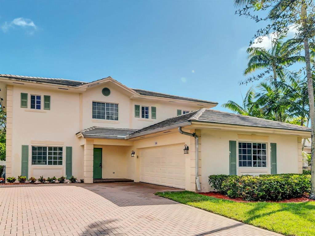 308 Northwest 17th Terrace Pompano Beach, FL 33069 - Photo 42 of 43 a front view of a house with a yard and garage