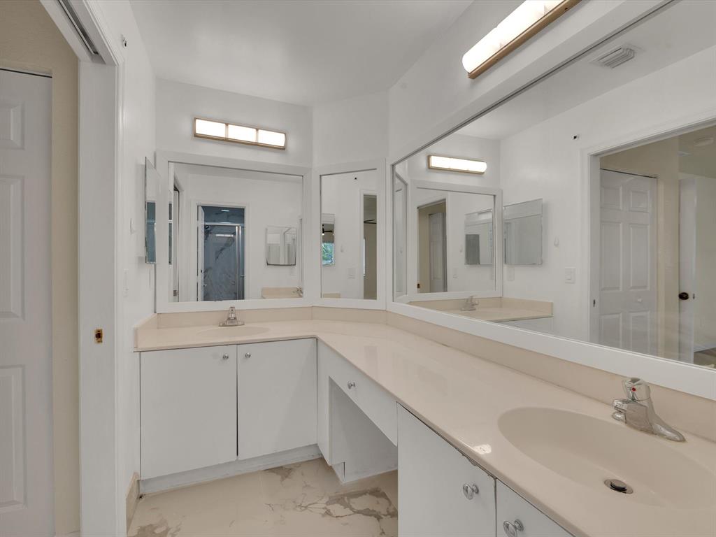 308 Northwest 17th Terrace Pompano Beach, FL 33069 - Photo 9 of 43 a spacious bathroom with a sink and mirror