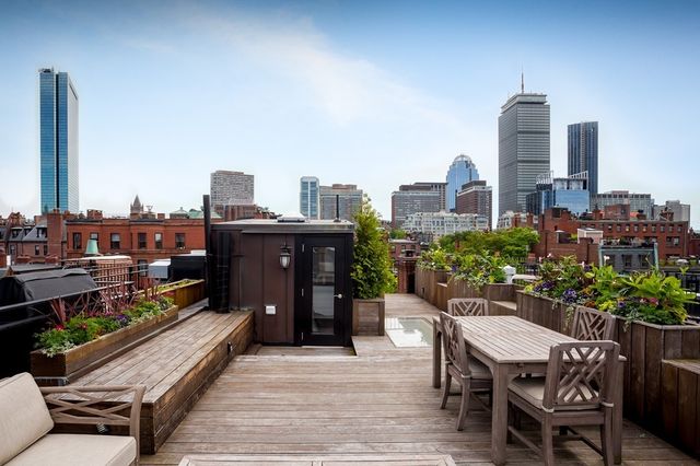 a view of a roof deck with furniture