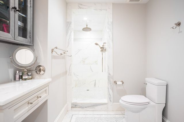 a bathroom with a sink a toilet and shower