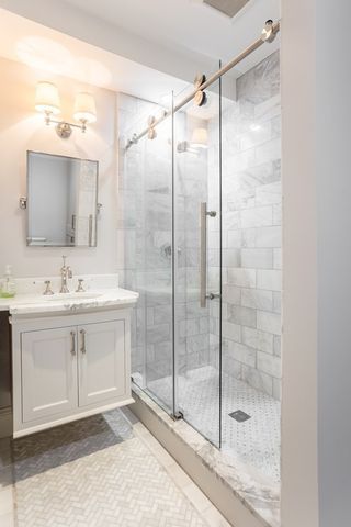 a bathroom with a shower sink and mirror