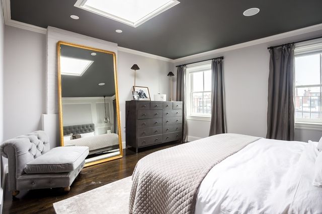 a bedroom with a bed and a couch