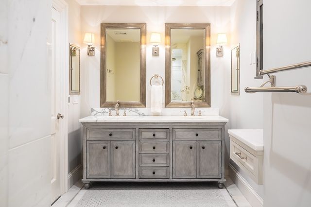 a spacious bathroom with a double vanity sink a large mirror and a