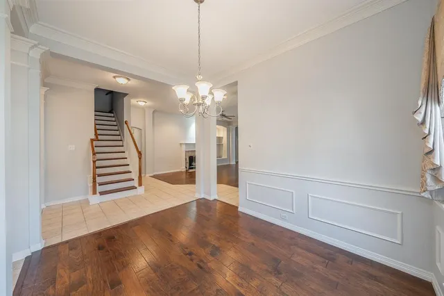 a view of a livingroom with wooden floor and stairs