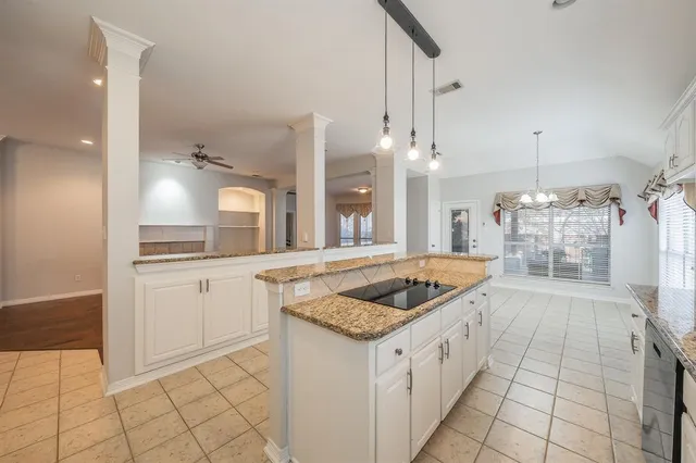 a kitchen with stainless steel appliances granite countertop a sink and a stove