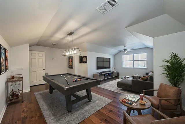 a living room with furniture a flat screen tv and a window