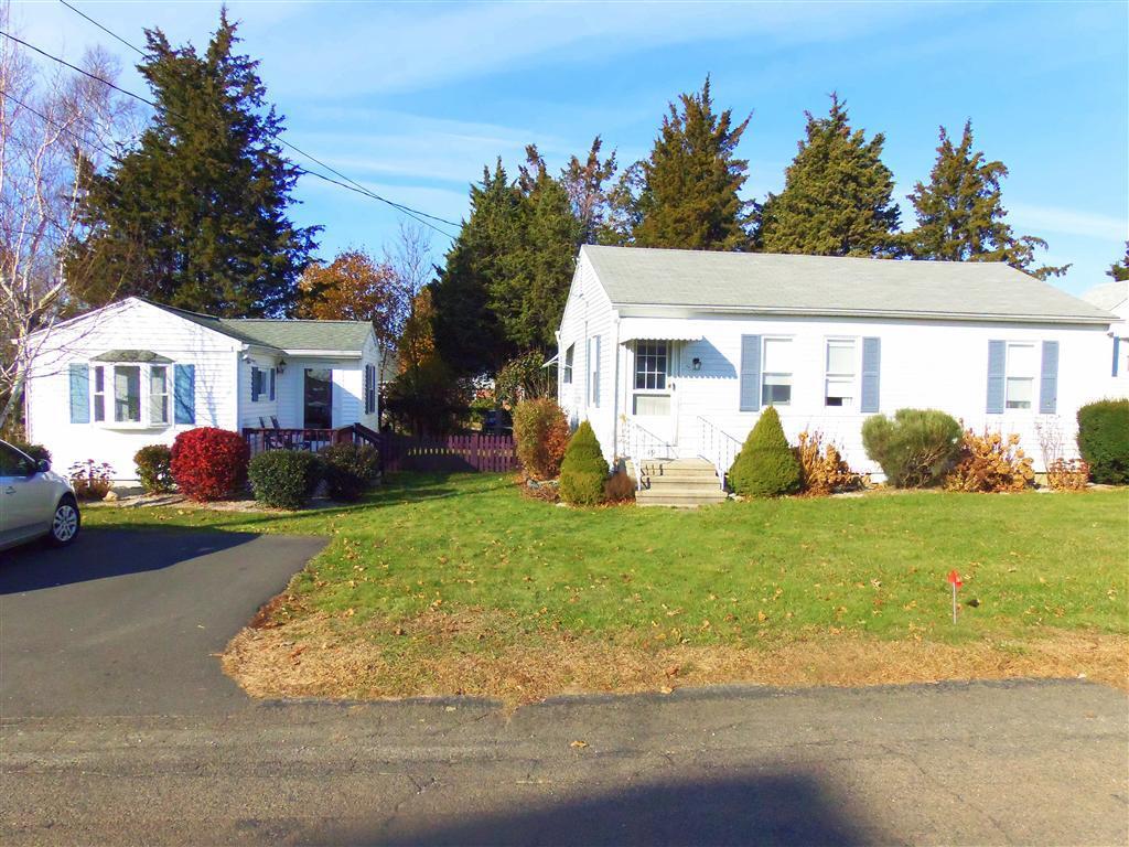 a front view of house with yard and green space