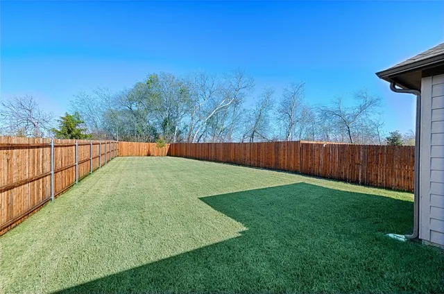 a backyard of a house with lots of green space