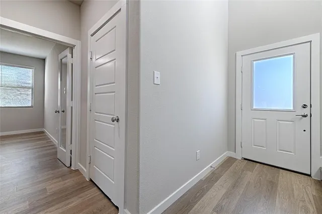 a view of a hallway with wooden floor