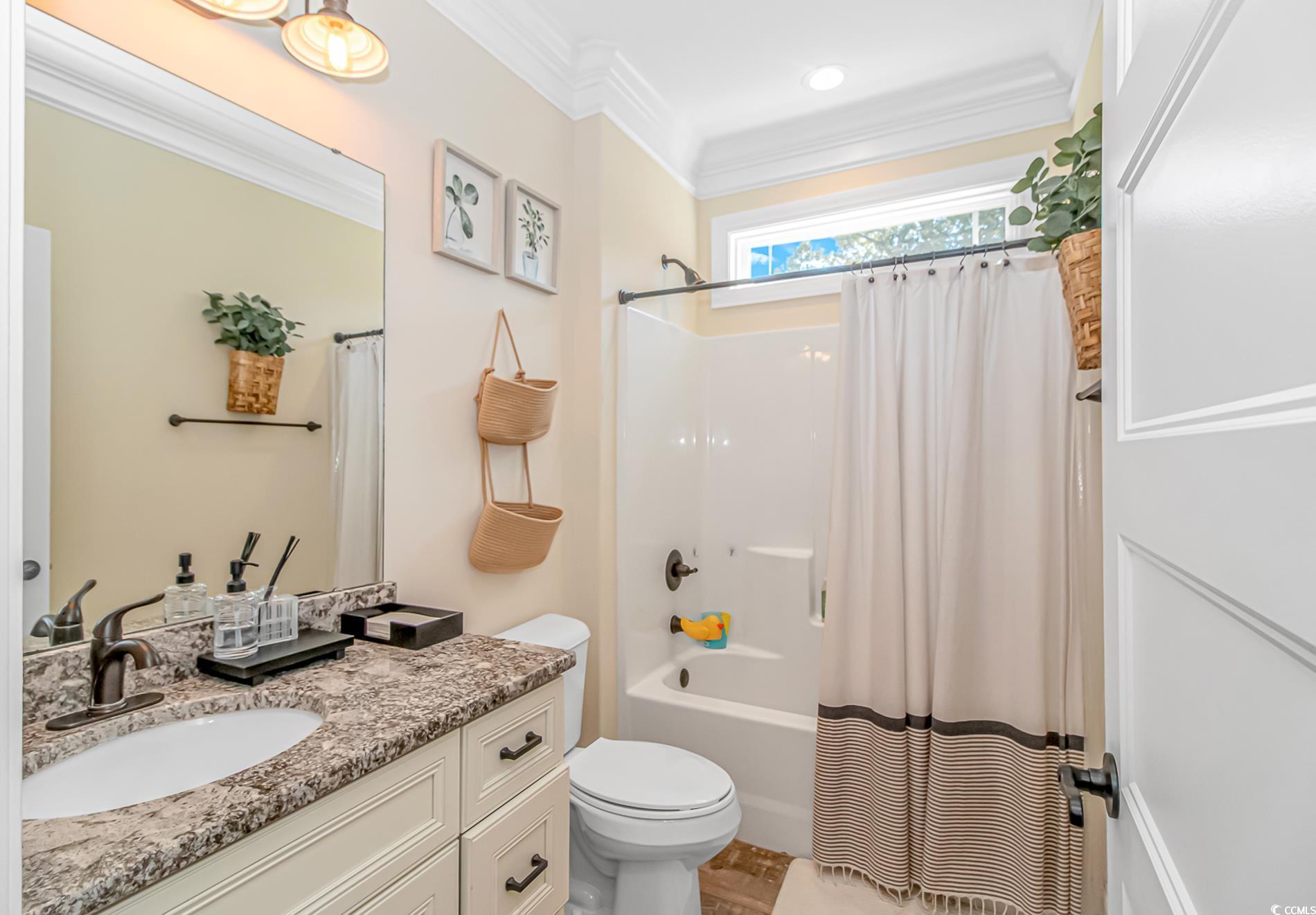 4383 River Road Little River, SC 29566 - Photo 17 of 40 Bathroom featuring shower / tub combo, crown molding, and vanity