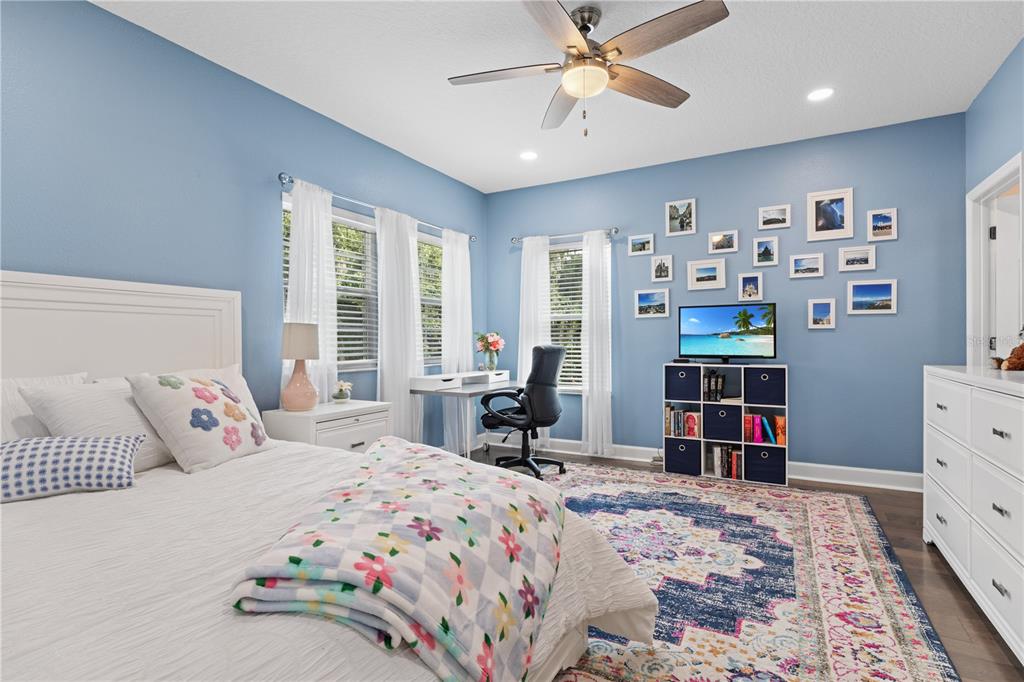 16948 Deer Island Road Tavares, FL 32778 - Photo 31 of 67 a bedroom with a bed and wooden floor