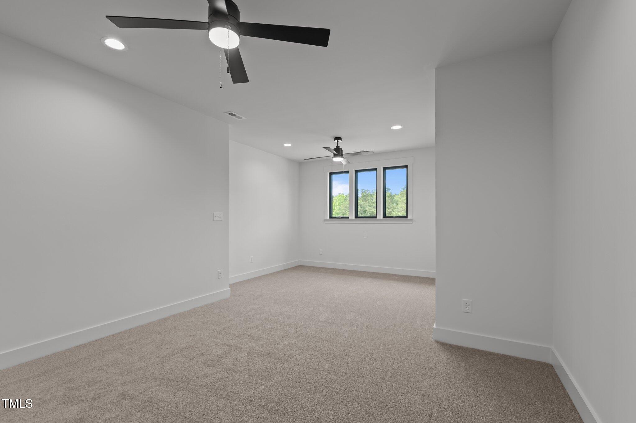 200 Broadleaf Lane Louisburg, NC 27549 - Photo 38 of 57 en empty room with windows and ceiling fan