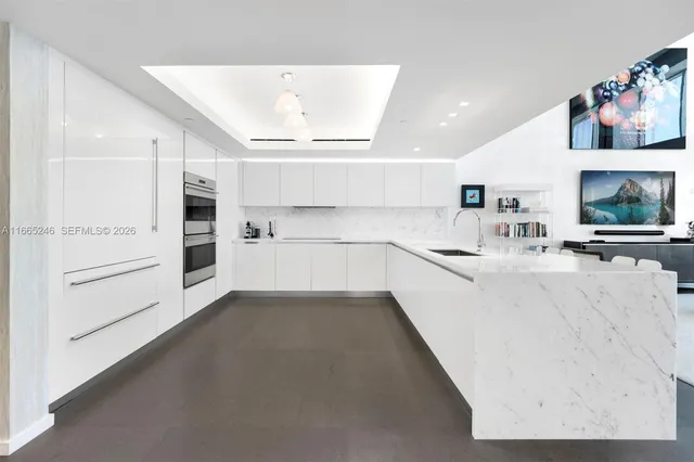 a kitchen with stainless steel appliances cabinets and a large window