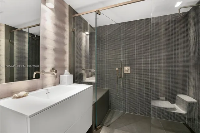 a en suite bathroom with a sink and a mirror