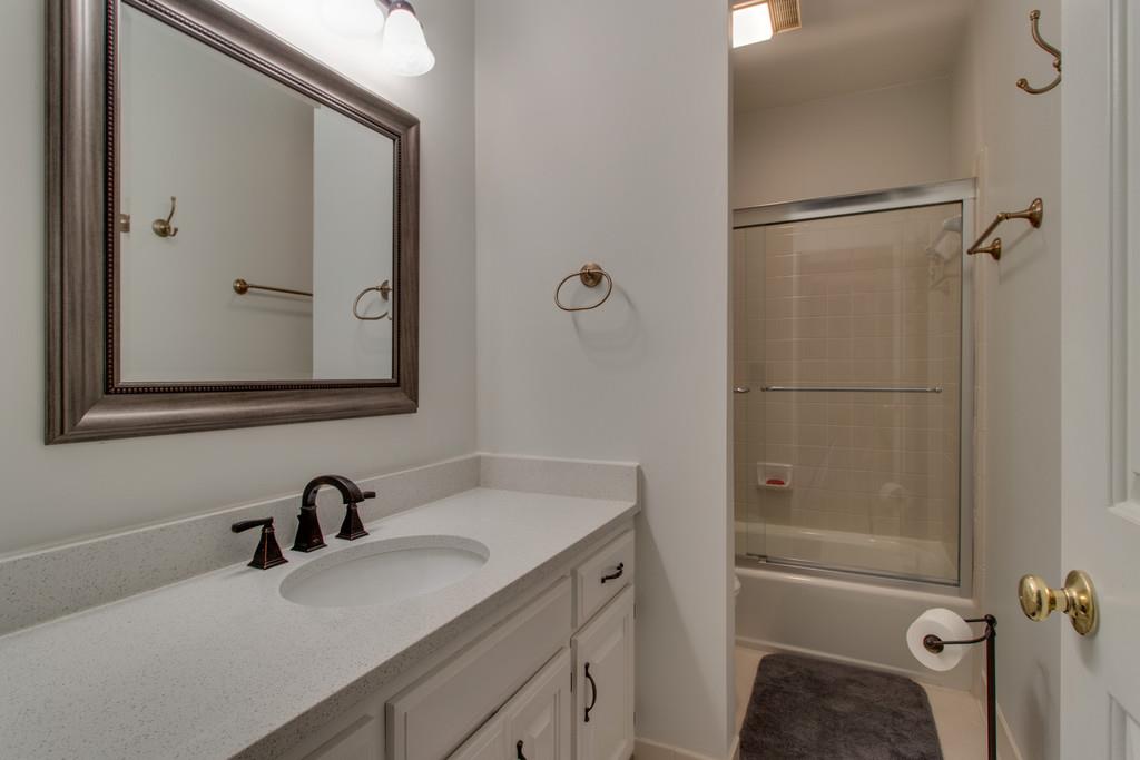8953 Sawyer Brown Road Nashville, TN 37221 - Photo 14 of 30 a bathroom with a tub sink vanity granite and mirror