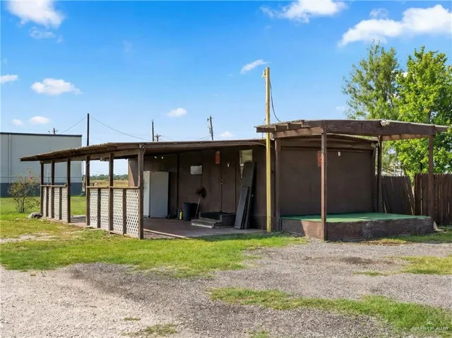 a view of a house with a yard and plants